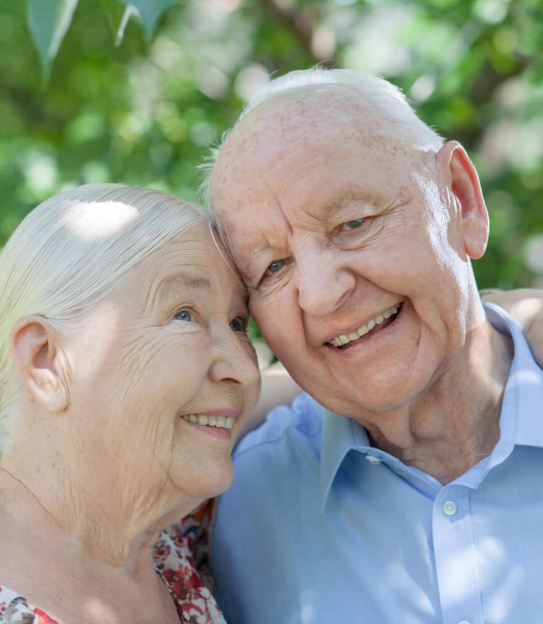 Happy older couple embracing, smiling together.