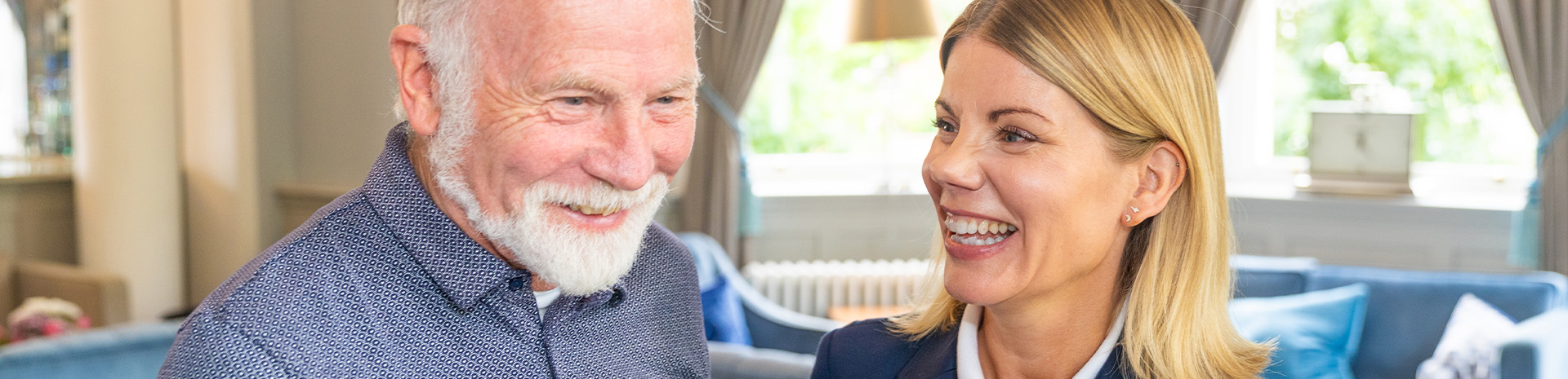 Resident with smiling staff member at care home 